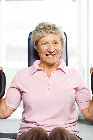 Senior lady working out at the gymの写真素材