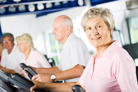 Group of older mature people exercising in the gymの写真素材