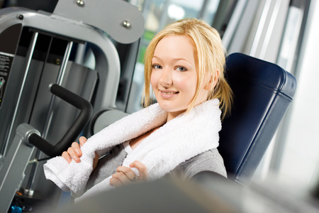 Young attractive blond girl exercising at the gymの写真素材