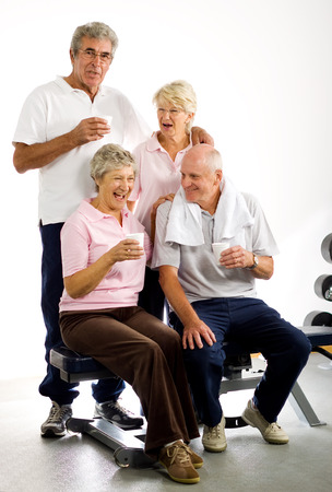 Group of older friends taking time out in the gymの写真素材