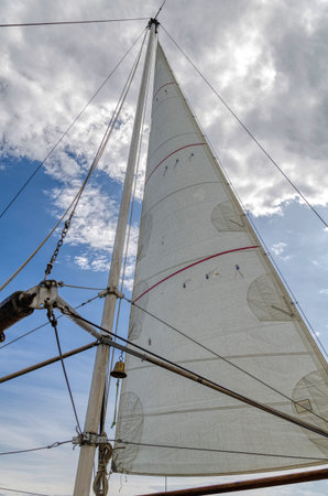 Sail of a sea vessel against a cloudy sky