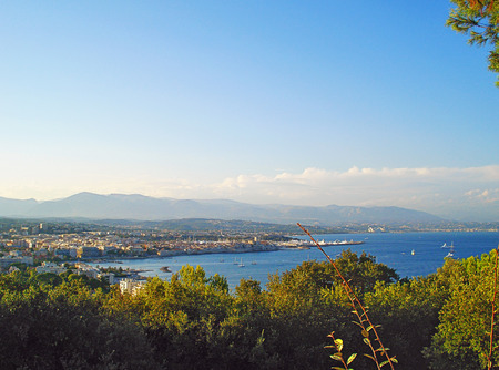 On this photo you can see panoramic view of Antibes from the cape Garoupe. At sunset green vegetation get a soft golden shade.の写真素材