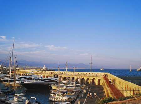 The old port of Antibes is intended for small walking yachts and boats. It is surrounded by a fortification wall which is part of fortification constructions of the Middle Agesの写真素材