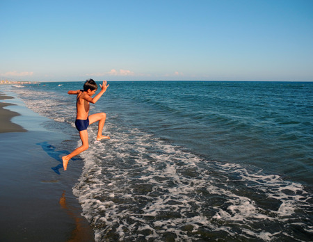 The boy's long-awaited meeting with the Adriatic sea on Long Beach in Ulcinj, Montenegro.の写真素材