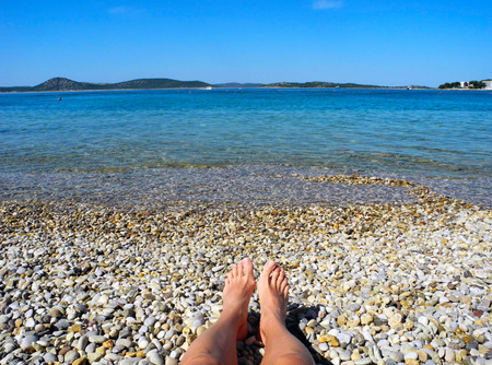 Relax on the beautiful pebble beach in Croatia.の写真素材