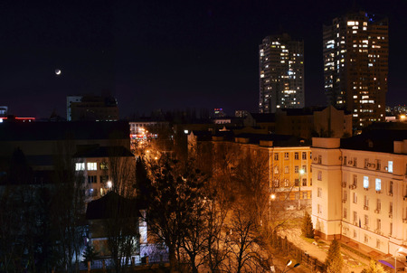  The young crescent moon over an evening city.の写真素材