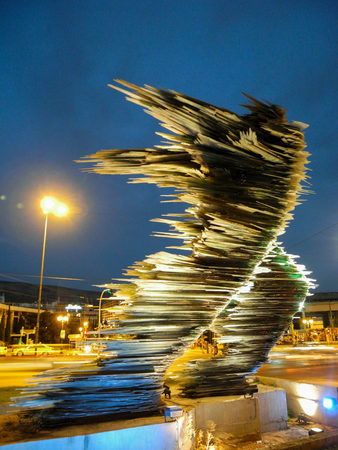 Athens, Greece - July 16, 2017: The Runner Man Glass Sculpture at Night.のeditorial素材