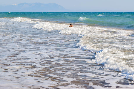 The boy in the sea wave surf. Kaifas beach, Greece.の写真素材