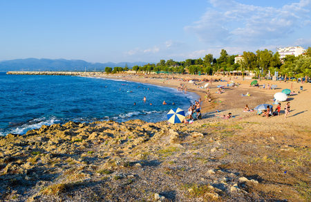 Greece - July 20, 2017: Vacationers sunbathe and swim on the beach of Kyparissia.のeditorial素材