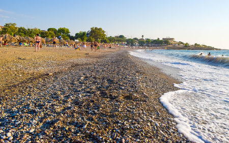 Kyparissia, Greece - July 20, 2017: Vacationers have fun, sunbathe and swim on the beach of Kyparissia.のeditorial素材