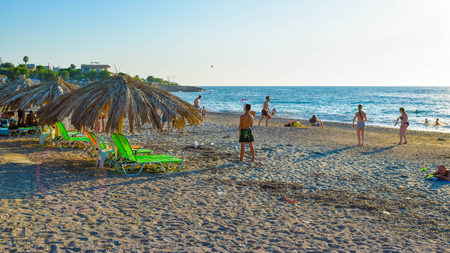 Kyparissia, Greece - July 20, 2017: Vacationers have fun, sunbathe and swim on the beach of Kyparissia.のeditorial素材