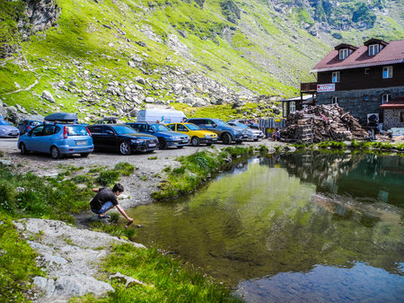 Transfagarasan road, Romania, - August 3, 2017: Tourists near the dam and lake Balea.