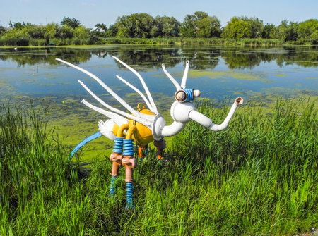Starokonstantinov, Ukraine - August 5, 2017: Sculpture of a fantastic creature, made of auto parts, river Ikopot, Ukraine.のeditorial素材