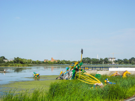 Starokonstantinov, Ukraine - August 5, 2017: Neptune's sculpture surrounded by fabulous creatures made from auto parts, the Ikopot River, Ukraine.のeditorial素材