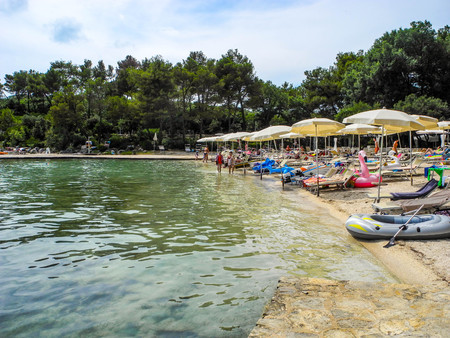 Pakostane, Croatia - July 6, 2018: Vacationers on the beach.のeditorial素材