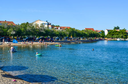 Srima, Croatia - July 08, 2018: Vacationers on the beach on a warm sunny day.