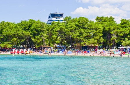 Vodice, Croatia - July 10, 2018: Vacationers on the beautiful pebble beach.のeditorial素材