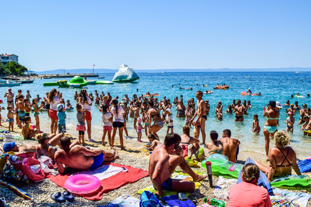 Promajna, Croatia - July 11, 2018: Animators "Neptune Club" and vacationers on the beach.のeditorial素材