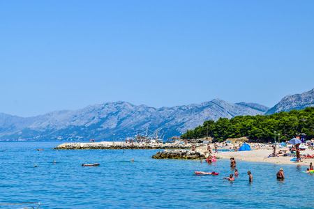 Promajna, Croatia - July 11, 2018: Vacationers on the public beach of the town of Promajna.のeditorial素材