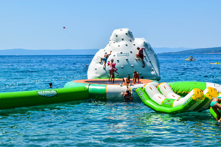 Promajna, Croatia - July 11, 2018: Vacationers on an entertainment slide.のeditorial素材