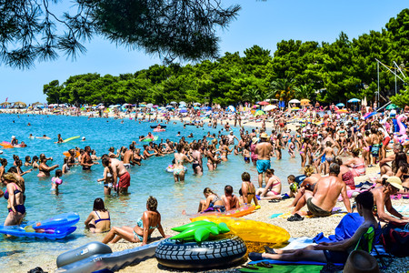 Promajna, Croatia - July 11, 2018: Vacationers on the public beach of the town of Promajna.のeditorial素材
