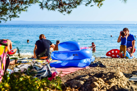 Baska Pole, Croatia - July 12, 2018: Vacationers on the public beach Baska Pole.のeditorial素材