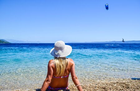 Girl on the beach of Zlatni Rat, Croatia.の写真素材
