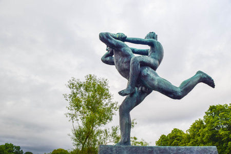 Oslo, Norway - June 16, 2019: Sculptures of man and child by Gustav Vigeland in Frogner Park.のeditorial素材