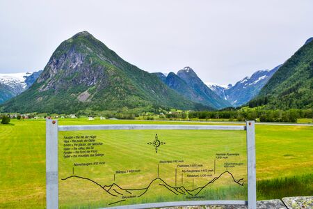 FjÃ¦rland, Norway - June 24, 2019: View of the glaciers of Jostedalsbreen National Park and the mountain landscape from the Glacier Museum (Bremuseum). An information plate gives names of the mountains.のeditorial素材