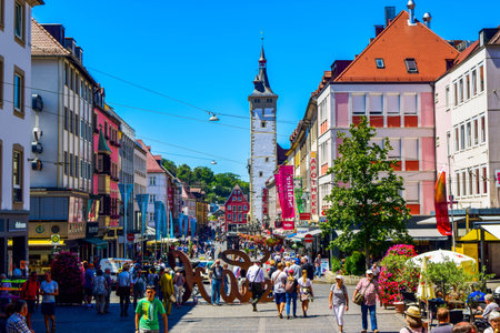 Wurzburg, Germany - July 4, 2019: Summer cityscape of Wuzburg. Tourists and residents on a street in...