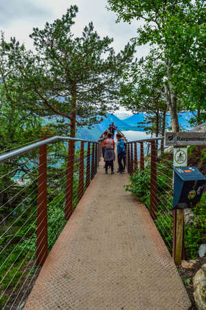Andalsnes, Norway - June 28, 2019: Tourists on the Rampestreken viewpoint, located at an altitude of 537 above the Romsdalsfjord (Romsdal Fjord) and Romsdalen Valley. Rauma Municipality.のeditorial素材