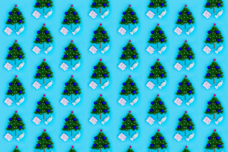 Repeating pattern of Christmas trees on a turquoise background. Christmas or New Year concept for...