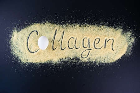 Collagen lettering made on gelatin. Gelatin and eggs are the main foods containing collagen, essential for youthful skin and healthy joints. Black background. Flat lay, top view. Copy space.の写真素材