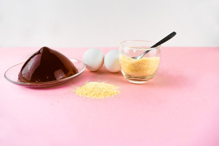 Jelly, gelatin and eggs are the main foods containing collagen, essential for youthful skin and healthy joints. Minimalist concept of proper nutrition. Light pink background. Copy space.の写真素材