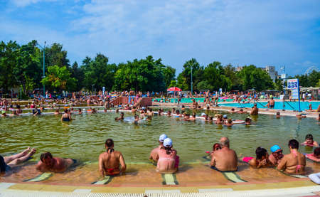 Hungary, Hajduszoboszlo - August 1, 2019: Vacationers in pools with medicinal water, tinged with natural iodine of the thermal resort spa complex Hajduszoboszlo.のeditorial素材
