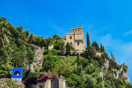 City tower on a cliff near Mediterranean Sea in Finale Ligure, Savona, Italy. Summer landscape. Copy...