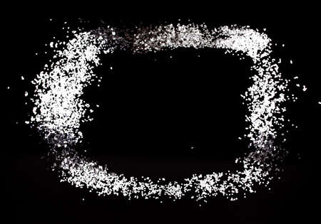 Black and white background. Frame made of white and silver metallic sequins on a black background.の写真素材