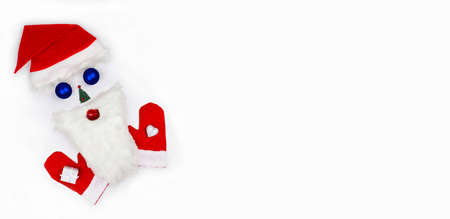 Santa Claus face made of Christmas toys, fir tree, beard and Santa's mittens on white background. Christmas symbol. Creative. Christmas greeting card. Flat lay.の写真素材