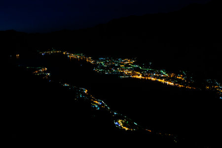 Night top view from Mount Vrmac to illuminated Bay of Kotor (Boka kotorska), also known as Boka and coastal towns at foot of mountain range Pestin Grad. Adriatic Sea. Balkan. Montenegro.の写真素材