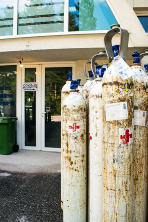 Pljevlja, Montenegro - June 27, 2021: Hospital doors with a sign: "Internal Infectious Diseases Ward" and a inscription: "Covid-19 Clean area" and pointer towards a clean area.のeditorial素材