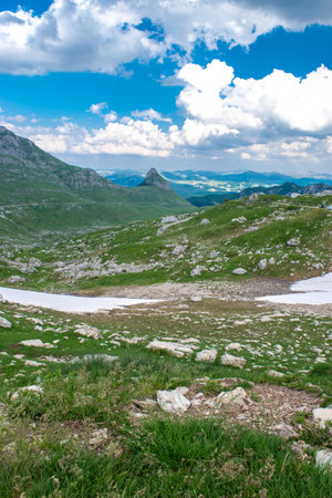 Mountains peaks and snow of the Durmitor National Park, along which picturesque high-mountain tourist road of northern Montenegro passes.の写真素材