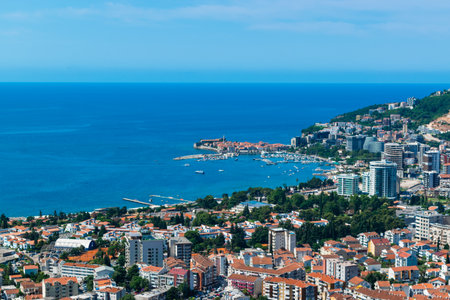 Panoramic landscape of resort Budva city on blue sky background. top view. The architecture of the old and new city, located on the Adriatic coast. Montenegro. Summer sunny day.の写真素材