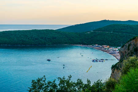 Panoramic top views of Jaz Beach in bay surrounded by green mountains. Sunset summer landscape. Budva Riviera. Montenegro.の写真素材