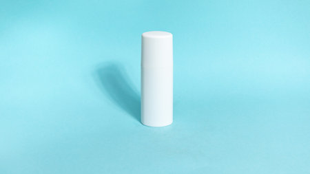 One white tube of skin care cosmetics on blue background. The concept of face and body skin care and anti-aging treatments. copyspace. flat lay.の写真素材