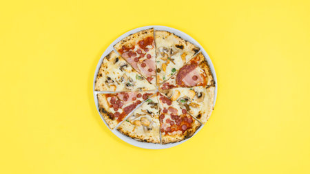 Pieces of pizza lie on a white plate. yellow background. Concept of a popular delicious food. flat...