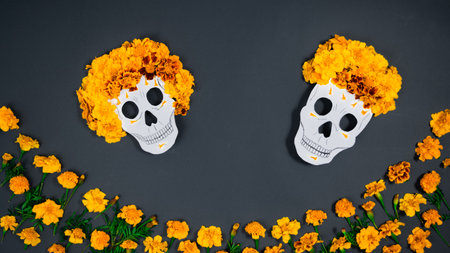 Heads of orange marigold flowers around white skeletons. Black background. Day Dead holiday. Ð¡heerful memories of deceased friends and family members. greeting card.の写真素材