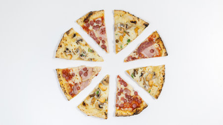 Slices of two types of pizza fn the shape of a circle on a white background. Popular delicious food concept. Copy scene.の写真素材
