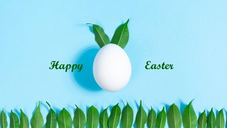 Happy Easter Holiday. White egg decorated with green leaves, symbol of Easter Bunny. Green leaves move cyclically like ears of an Easter bunny. Row of leaves is symbol of lawn.の写真素材