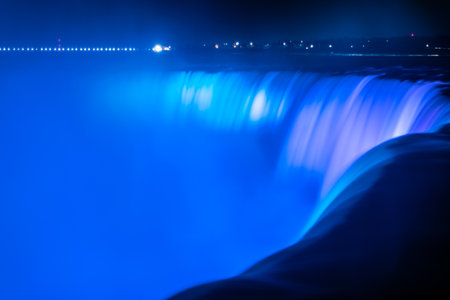 Blurred streams of Niagara Falls, illuminated in blue in the evening. Canada. One of the world's main attractions. Close-up.の写真素材