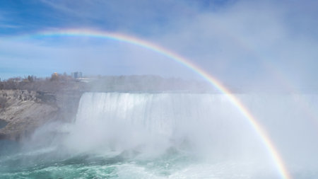 Beautiful view of Horseshoe Falls, largest of three waterfalls of Niagara Falls. Bright rainbow in foreground. Cloud of water rises nearby. View from Canadian side.の写真素材